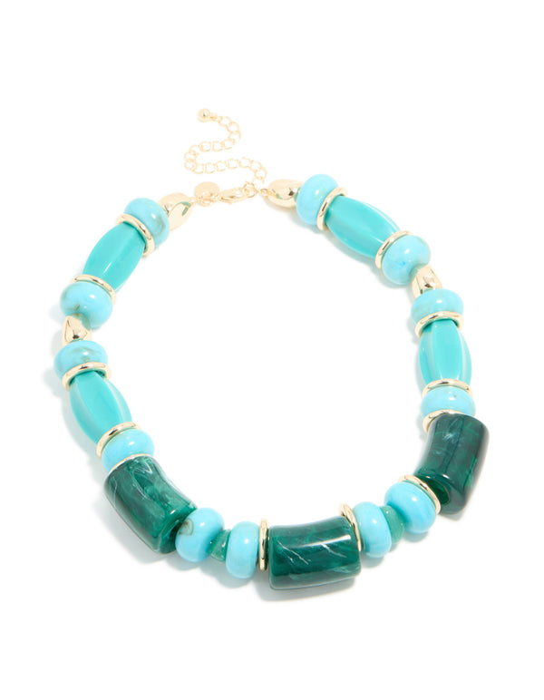 Designed with beads in turquoise material featuring square and round with gold accents, this chunky necklace is shown in front view