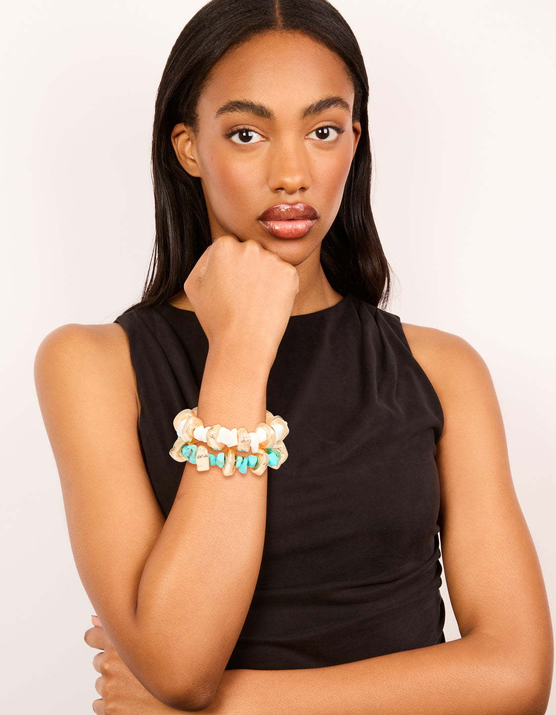 Styled beaded stretch bracelets in a 2-pack with blue, gold, and white on model view