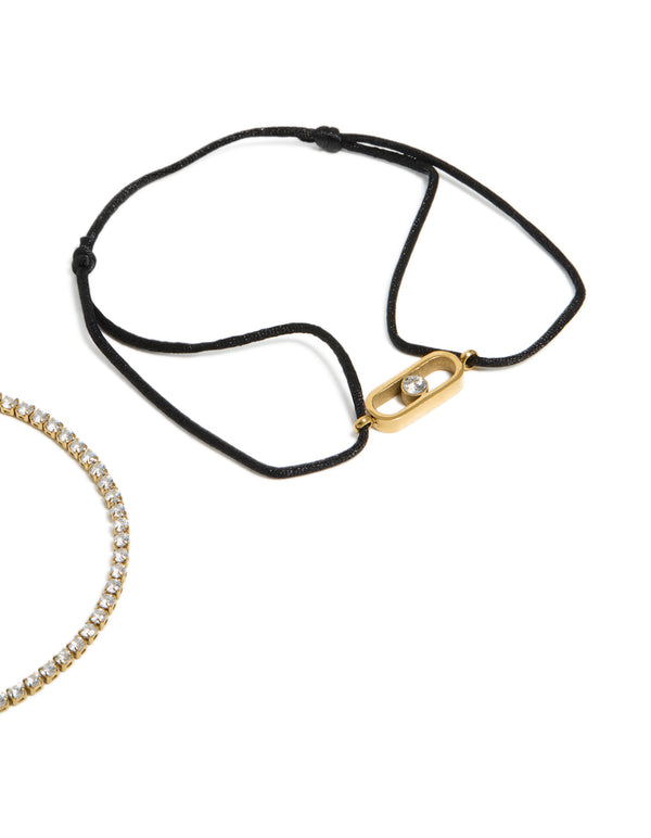 Elegant waterproof tennis bracelet set in gold plated stainless steel with cubic zirconia and black cord featuring a statement style in close up view