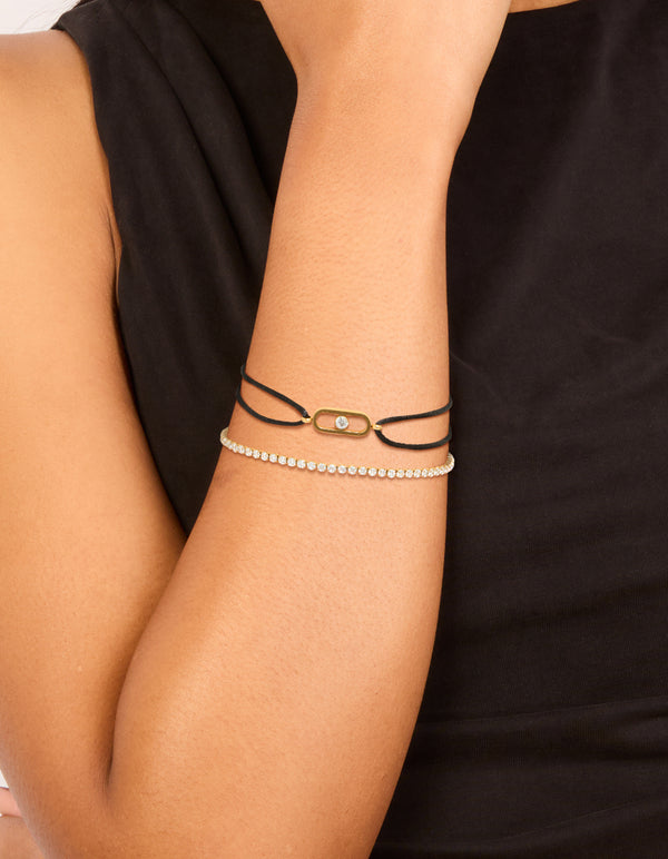 Explore this waterproof tennis bracelet set featuring gold plated stainless steel with cubic zirconia and black cord in a statement style on wrist view