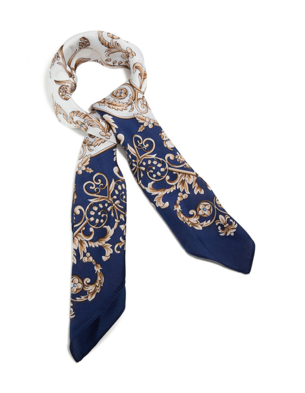 Showcasing a dark blue and white baroque flower polyester fabric scarf featuring leaf and floral patterns in navy, tan, and gold front view