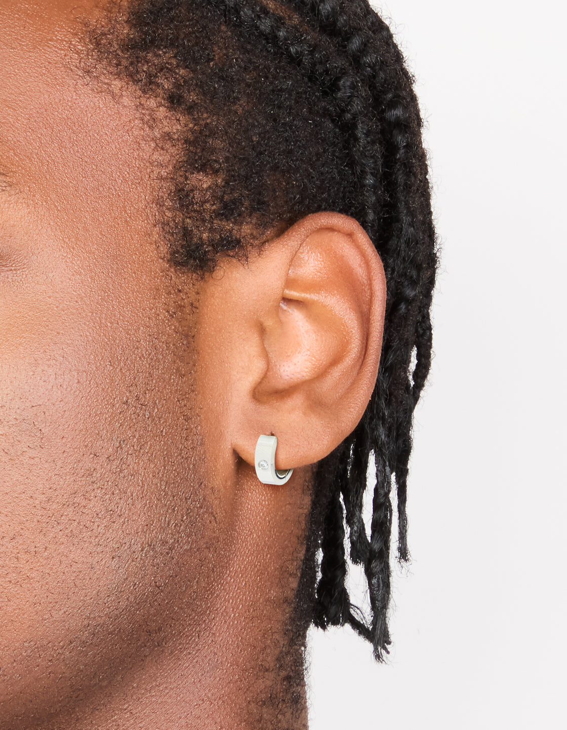 Showcasing mens waterproof stainless steel cubic zirconia huggie earrings on ear view