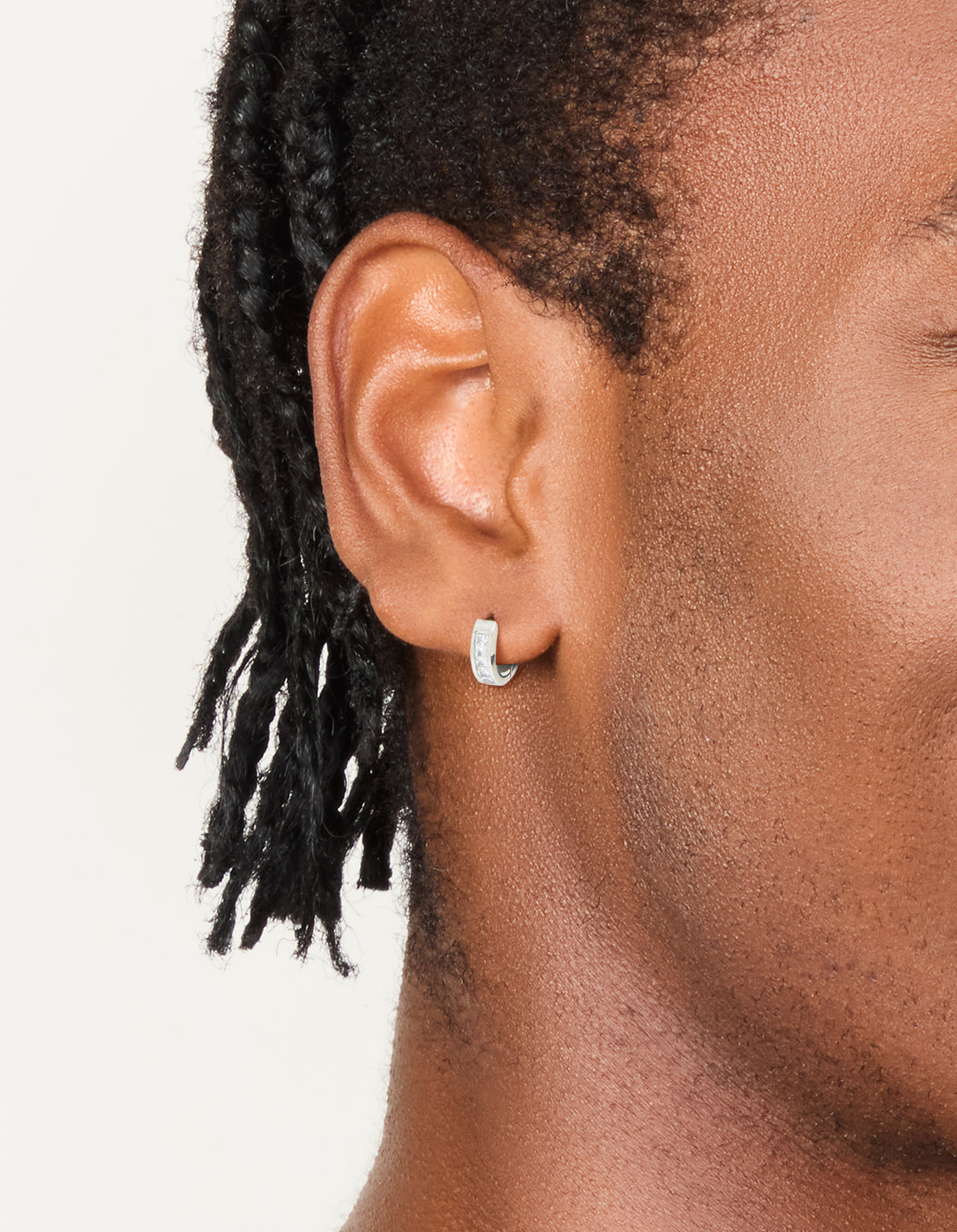 Featuring mens waterproof stainless steel square cubic zirconia huggie earrings in silver on ear view