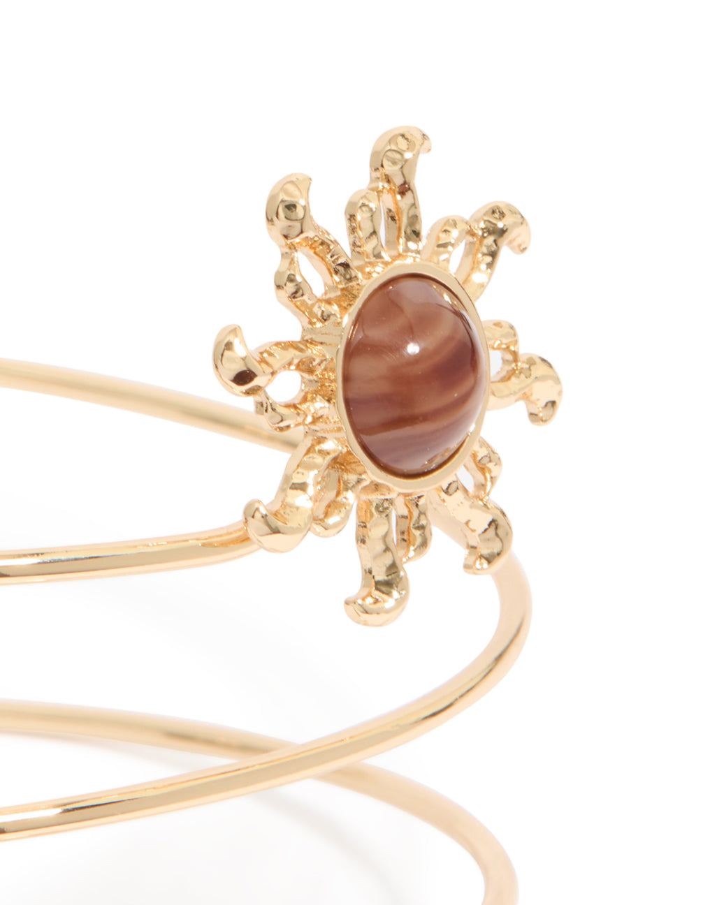 Gold sun and swirl arm cuff with celestial design close up view