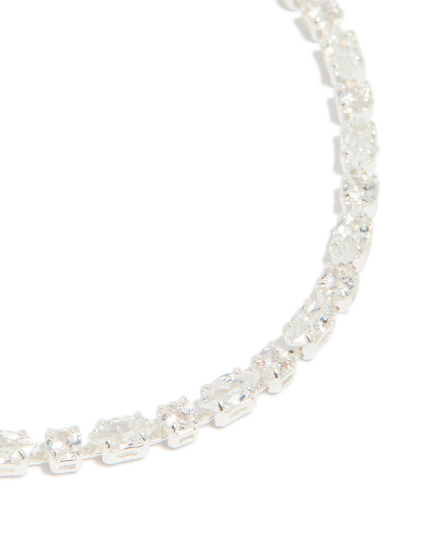 Highlighting the oval cut cubic zirconia stones, this silver plated dainty tennis bracelet is presented in close up view