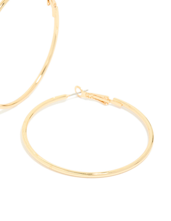 Crafted from gold plated material, thin hoop earrings with fastening post detail view
