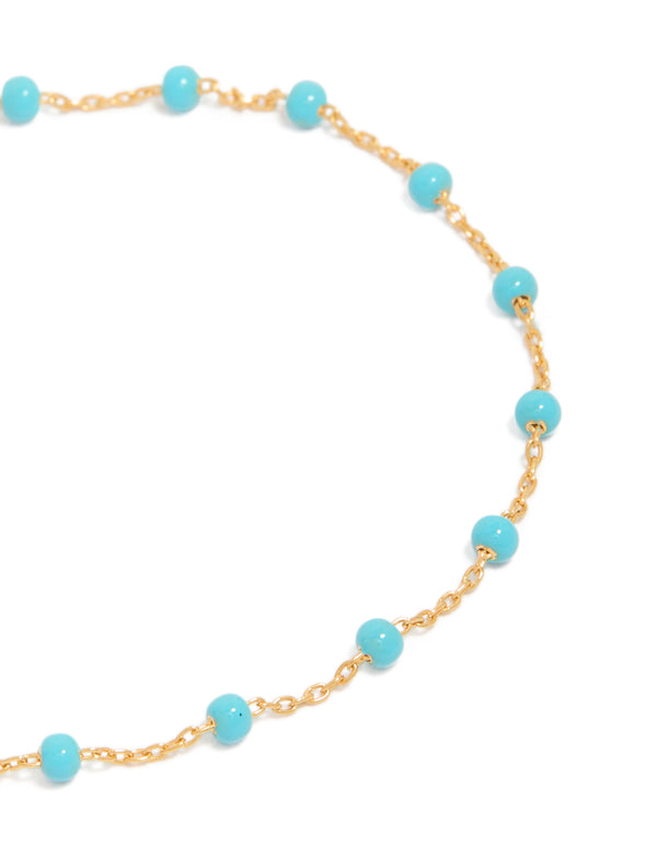 Featuring gold plated sterling silver with blue enamel beads in turquoise station bracelet close up view