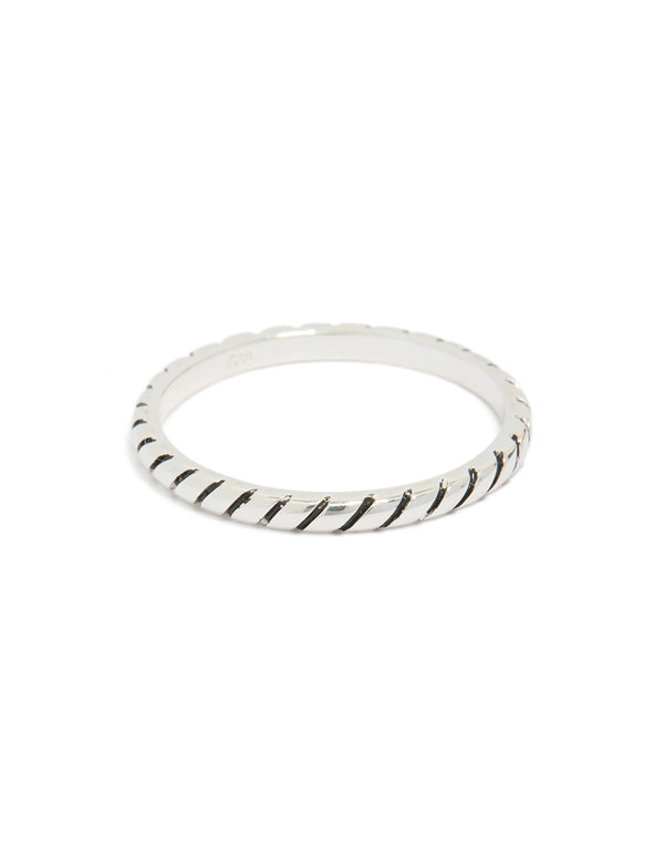 Showcasing a textured sterling silver statement ring with black enamel detailing front view