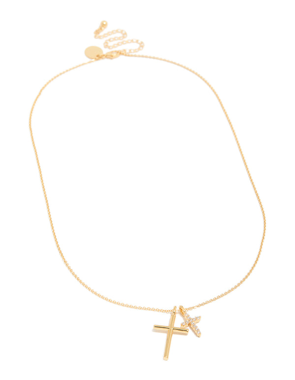Highlighting a brass double cross necklace with charm featuring cubic zirconia in gold plated finish, statement pendant style front view
