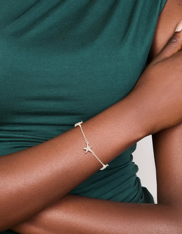 Elegant silver plated cubic zirconia pave starfish charm toggle bracelet worn on wrist view