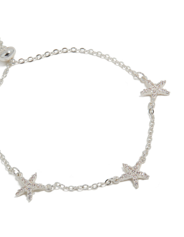 Featuring delicate starfish charms, this silver plated cubic zirconia pave toggle bracelet in close up view
