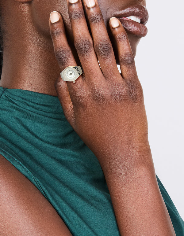 Showcasing a silver diamante face watch ring crafted from stainless steel with white details and statement styling on finger view