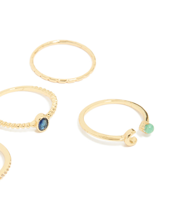 Featuring gold plated celestial rings with blue cubic zirconia moon and star motifs in a 5-pack close up view