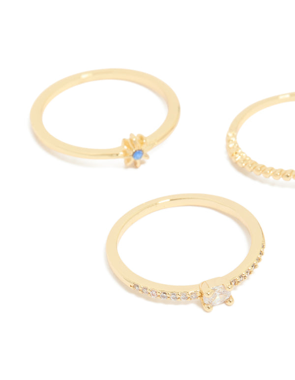 Crafted from gold plated material, celestial rings with blue cubic zirconia moon and star accents in a 5-pack side detail view