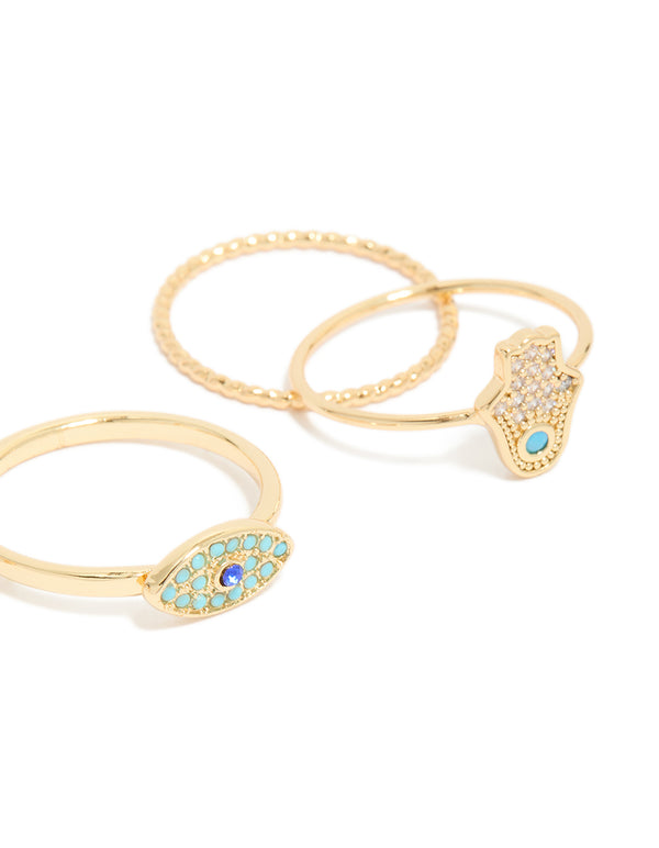 Designed with gold plated cubic zirconia evil eye and hamsa hand rings 4-pack, featuring celestial sun motifs details in crystal and statement style close up view