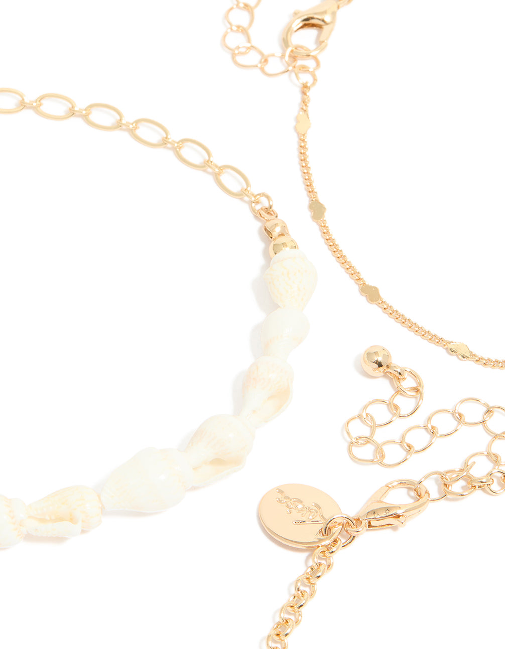 Crafted with gold shell and starfish ocean-inspired charm details and pearls 3-pack anklets side view