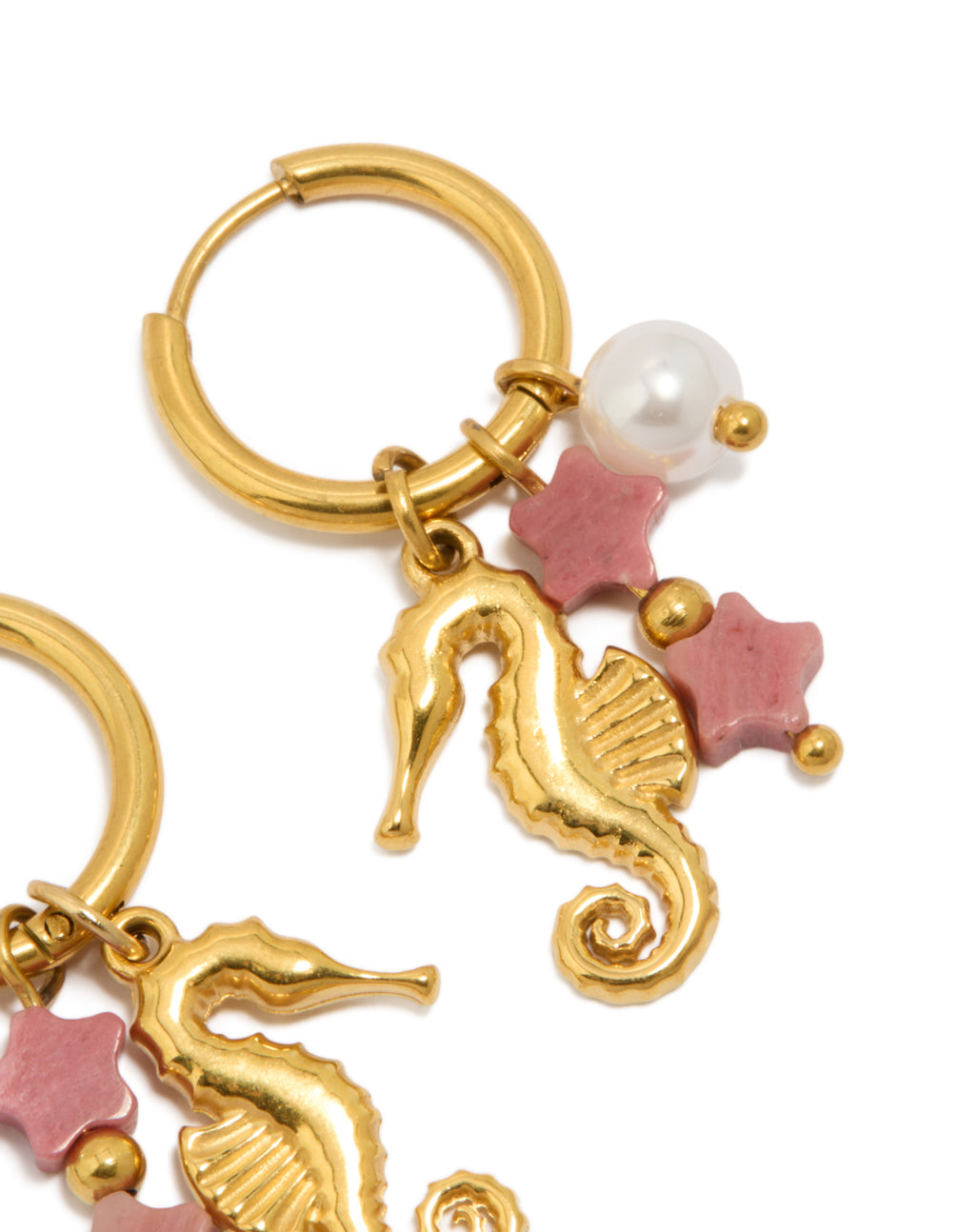 Featuring waterproof gold plated stainless steel seahorse pearl charm huggie earrings with ocean design in pink and white post detail view