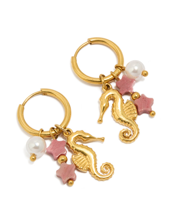 Discover waterproof gold plated stainless steel seahorse pearl charm huggie earrings with ocean celestial motifs featuring in light pink and white front view