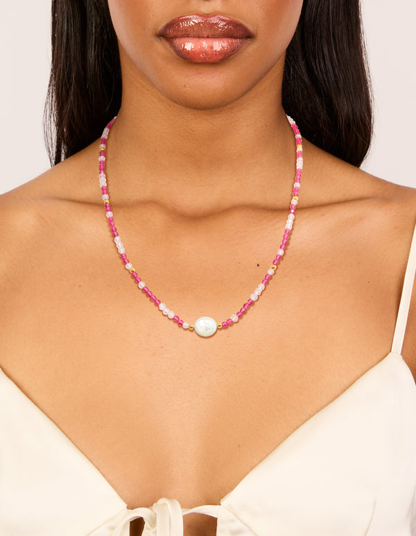 Designed with waterproof beaded necklace featuring pearl crafted from gold plated stainless steel in pink on neck view