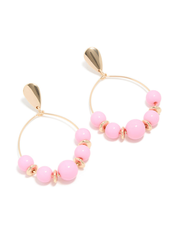 Statement drop earrings in gold featuring round pink beaded hoops front view