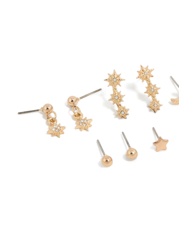 Showcasing gold diamante earrings 7-pack featuring ball star and moon designs with glitter accents and stud closure close up view