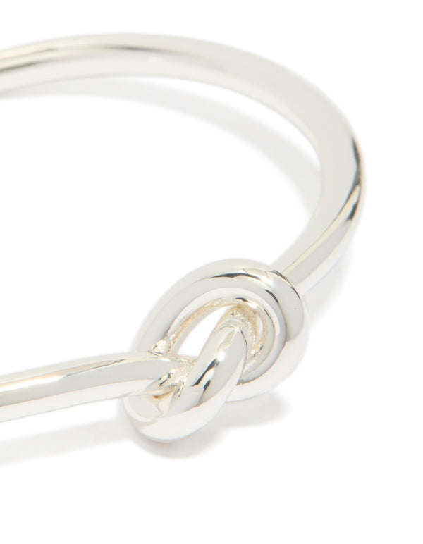 Featuring a dainty wrist cuff bangle in silver plated metal with knotted detail close up view