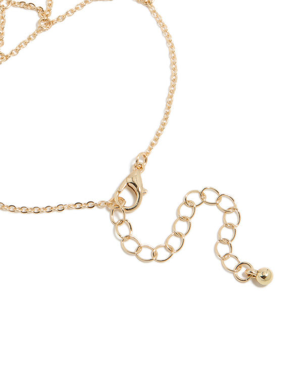 Crafted with a statement gold mesh hand chain bracelet showcasing closure detail view