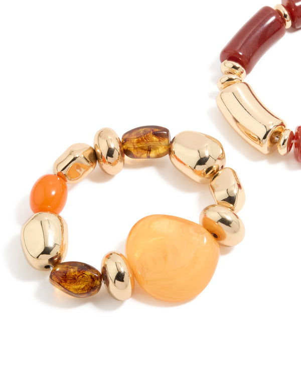 Detailed view of beaded stretch bracelets in a 2-pack with irregular acrylic and gold accents in maroon, orange, and peachpuff hues, close up view
