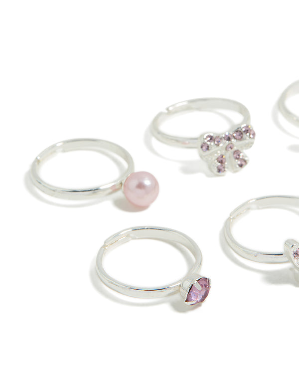 Crafted from silver, kids diamante bow, pearl and butterfly rings in pink and plum close up view