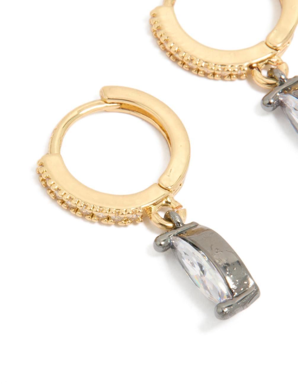Designed with mixed metal plated cubic zirconia oval huggie drop earrings in gold, silver, and clear stone close up view