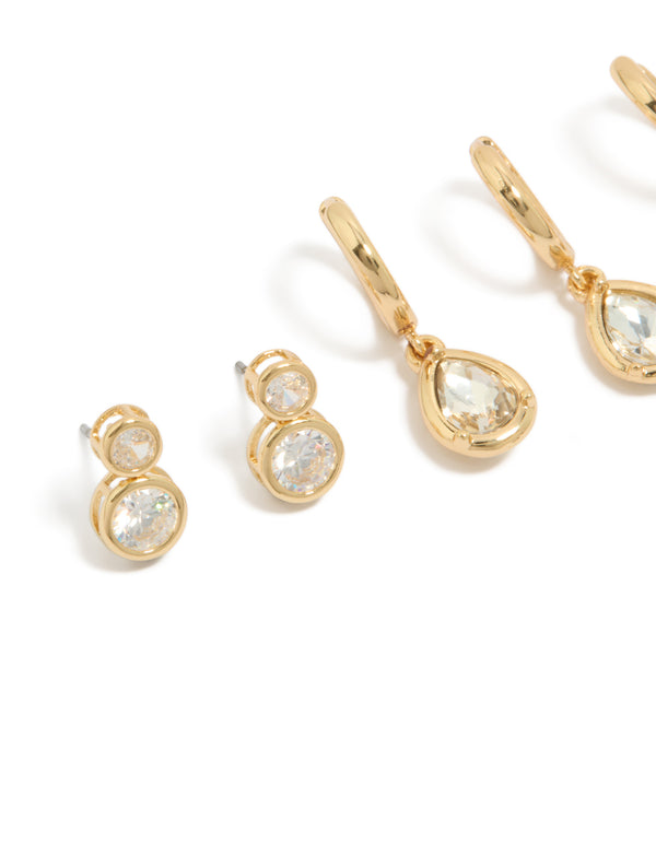 Featuring gold plated cubic zirconia large bezel set studs and huggie earrings in a 3-pack close up view