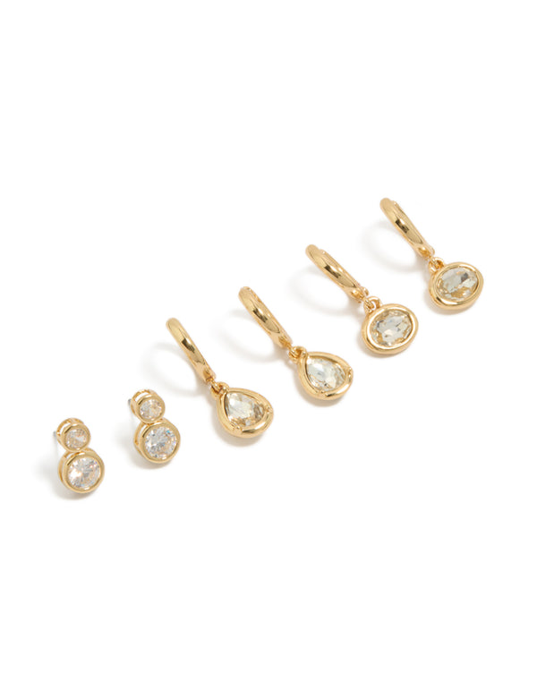 Showcasing gold plated cubic zirconia large bezel set studs and huggie earrings in a 3-pack front view