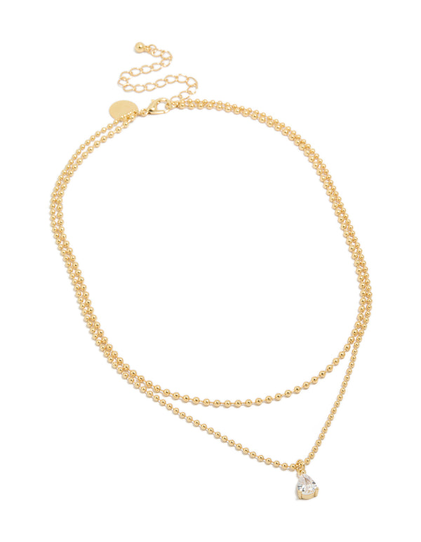 Discover this gold plated cubic zirconia teardrop pendant and ball layered necklace featuring crystal in dainty style front view