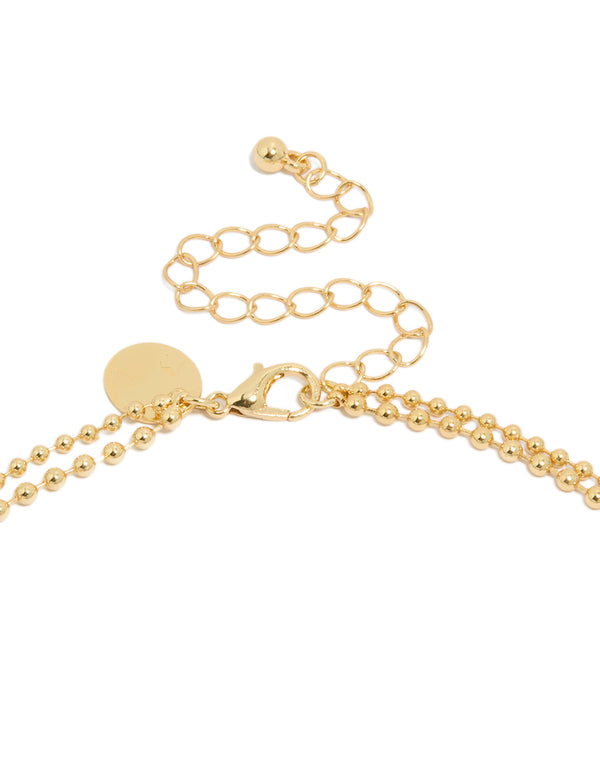 Presenting a gold plated cubic zirconia teardrop pendant and ball layered necklace featuring crystal in dainty style clasp detail view