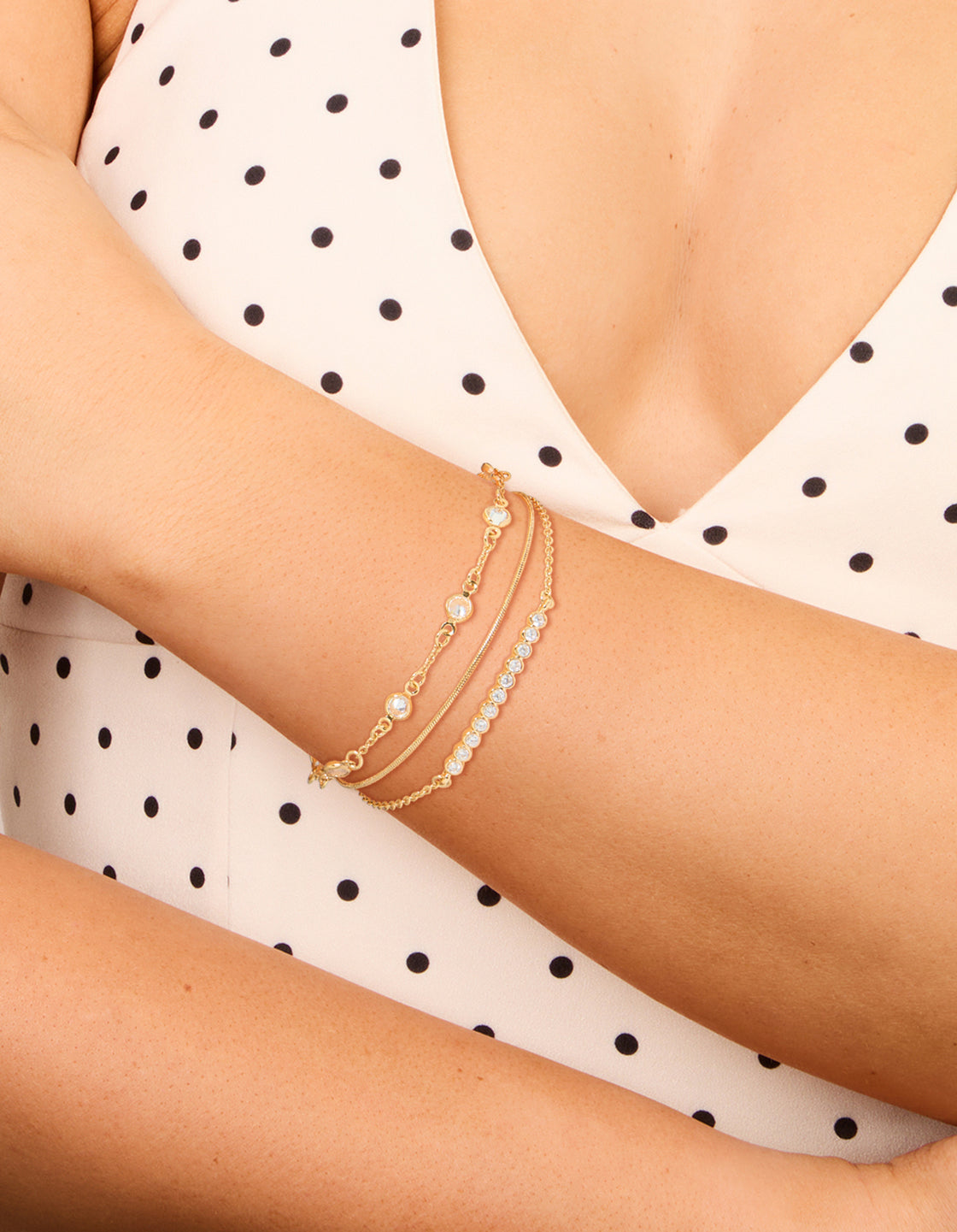 Designed with gold plated cubic zirconia bezel stone bracelets in a 3-pack on wrist view