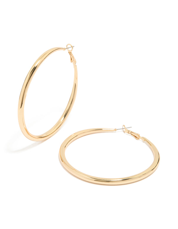 Showcasing large hoop earrings crafted from gold plated material with hoop closure front view