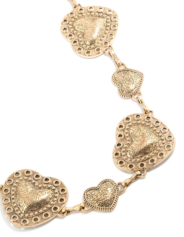Showcasing an antique gold western heart belt with embellished waisted design in a statement styling detail view