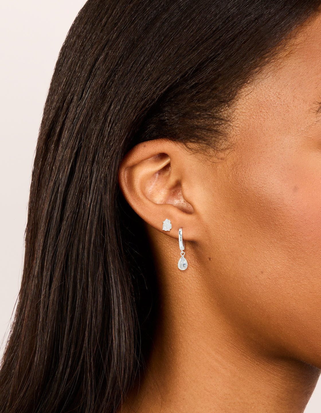 Featuring silver plated cubic zirconia hoop and stud earrings 2-pack on ear view