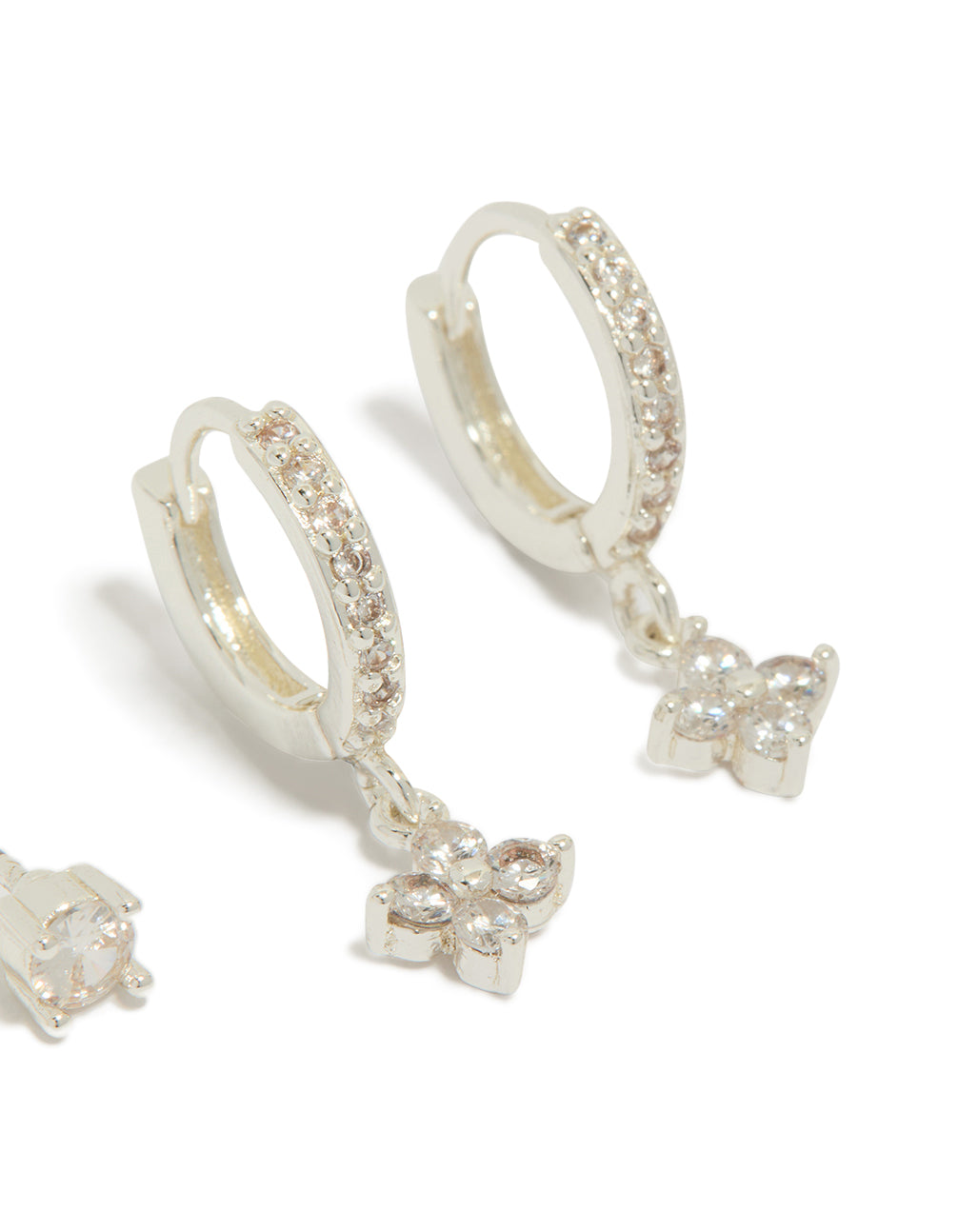 Designed with silver plated cubic zirconia studs and flower huggie earrings in a 2-pack close up view