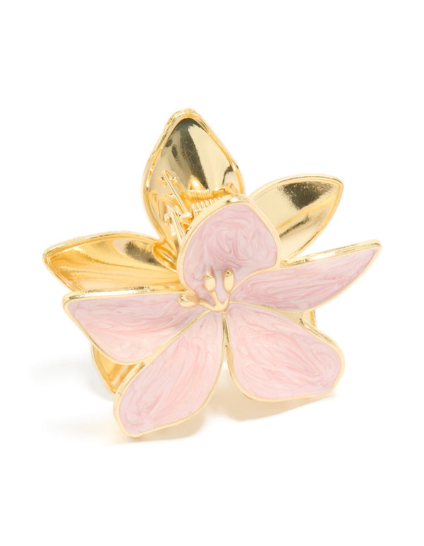 Featuring a light pink enamel floral claw clip with gold accents side view
