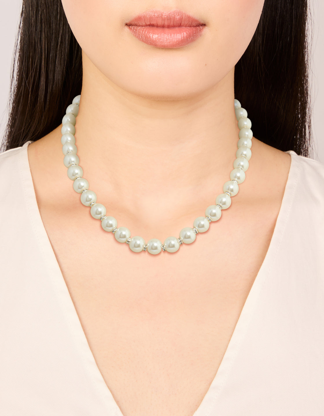 Elegant pearl necklace with silver plated diamante rondells shown on neck view