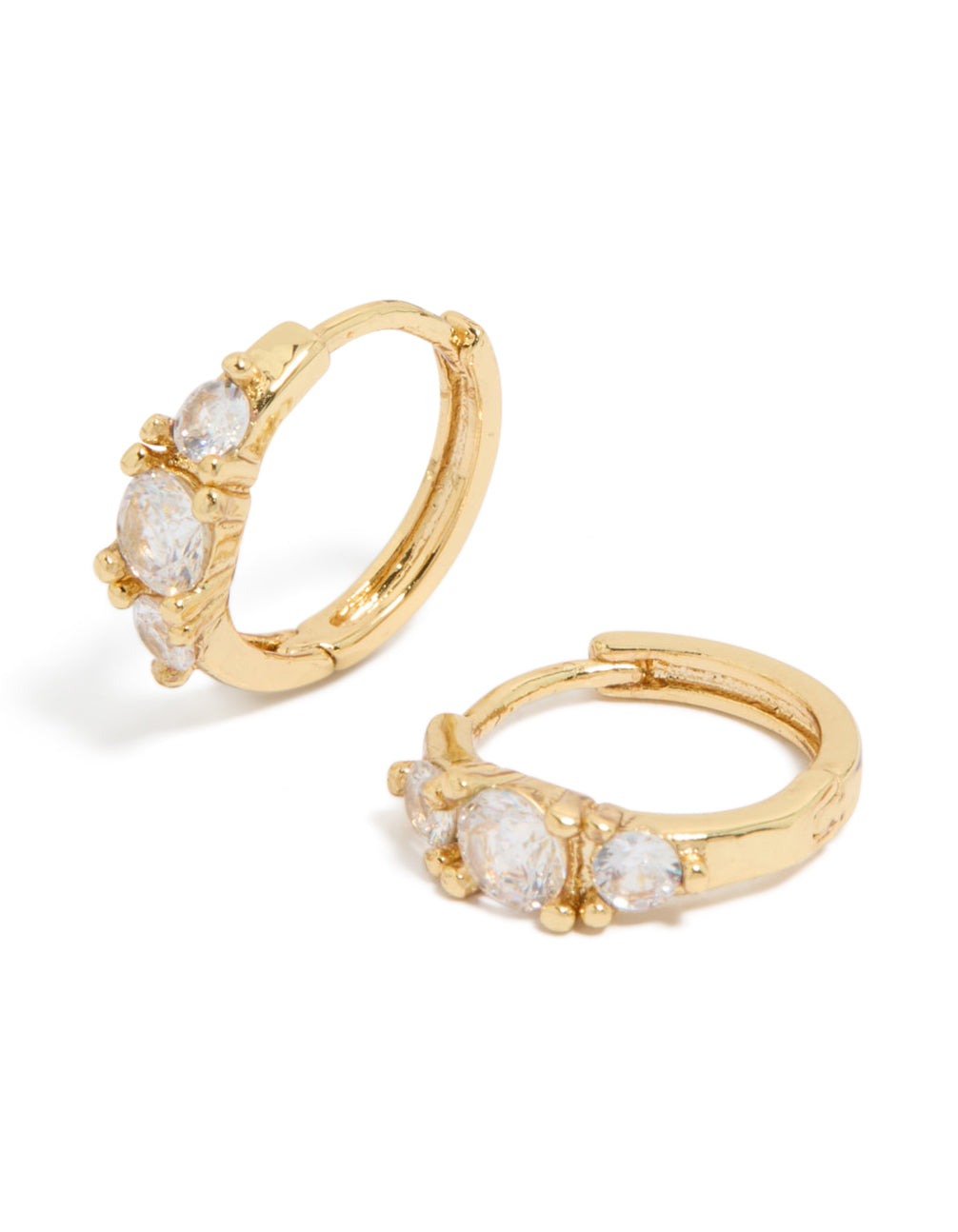 Showcasing gold plated mixed sized cubic zirconia mini huggie earrings with huggie closure front view