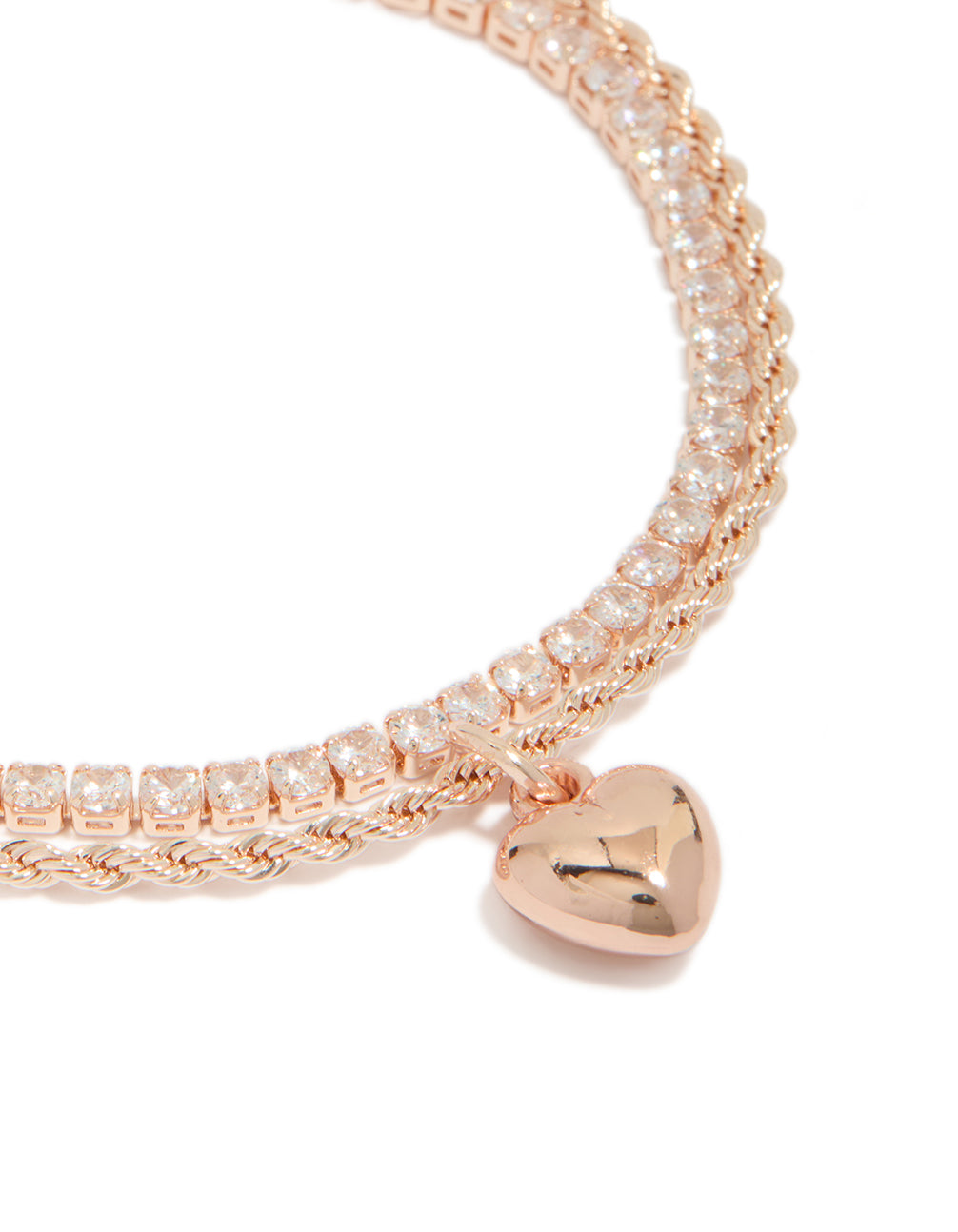 Crafted from rose gold plated cubic zirconia tennis and heart layered bracelet close up view