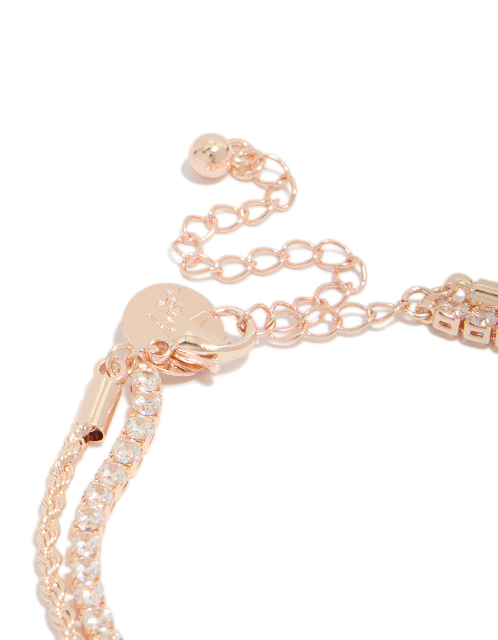 Highlighting a rose gold plated cubic zirconia tennis and heart layered bracelet closure detail view