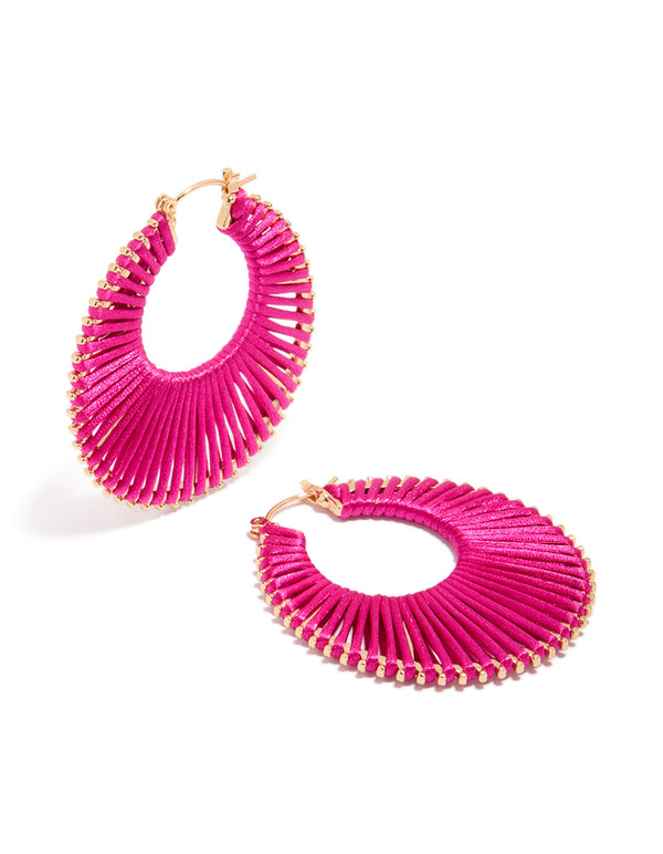 Beautifully crafted hot pink threaded hoop earrings in statement style with gold accents front view