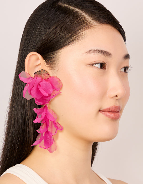 Designed with hot pink fabric flower drop earrings featuring statement design on model view