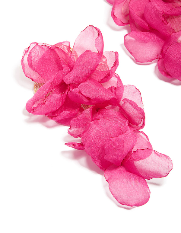 Crafted from hot pink fabric, these flower drop earrings feature statement design close up view