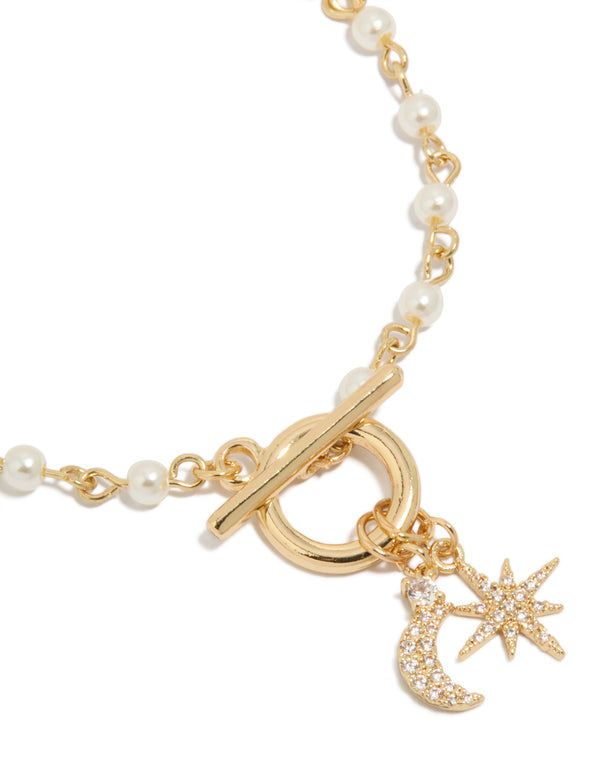 Crafted gold plated bracelet showcasing intricate cubic zirconia celestial star and moon charm with pearl details close up view