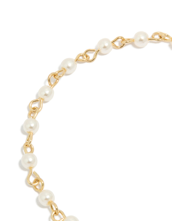 Crafted gold plated bracelet showcasing intricate cubic zirconia celestial star and moon charm with pearl details close up view
