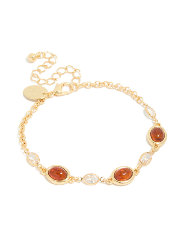 Featuring a gold plated bracelet with cognac beads and clear cubic zirconia in a tennis style front view